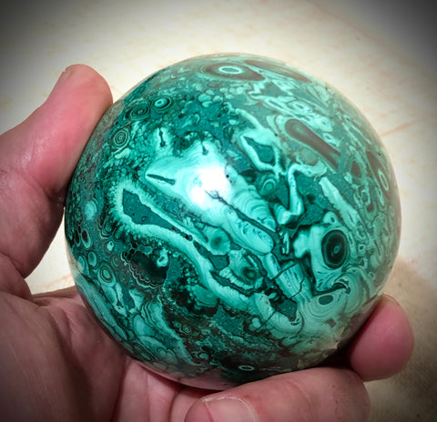 This malachite sphere shows off rosettes and layered structures typical to the mineral.  Weight - 1 lb , 12 ounce (785 grams)