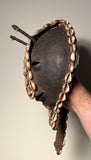 Batammariba Mask
Kuiye
The Sun , the Father and the Mother. 
Iron 
Early 20th century 
West Africa

9” x 10” x 4” ( excluding Cowrie Shell head strap )
Head strap measures 21” long.

Iron mask depicting Kuiye the Sun God. 
Made by the Batammariba people of Benin and Togo. 
Cowrie shell detailing surrounds the iron mask. Two lines of Cowrie shells are sewn onto leather head strap.

