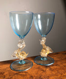 A beautiful pair of blue and gold Venetian Dolphin Goblets.  Handblown Glass. Island of Murano. Salviati Studio. Circa 1960.  Aquamarine Glass with 24 Karat Gold Dolphins.  6.5” tall x 3" diameter  excellent condition   