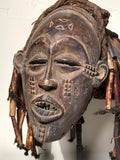 T schokwe Mask mwana pwo  Zaire  early 20th century   Carved Wood, fiber, beaded adornment.  9” x 12” x 15” tall  A popular and frequent occurrence in entertainment masquerades, mwana pwo represents a female ancestor but is always worn by a male dancer. This mask type symbolizes fecundity and the prominent role of women in Chokwe society