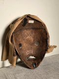 Bu Gle mask Dan Culture Liberia 20 th c. 10” x 8” x 3.5 “  Carved wood , earth paints, natural fibers , cloth and metal.  the Bu Gle mask of the Warrior round, projecting eyes mouth with metal teeth designed to be deliberately frightening.