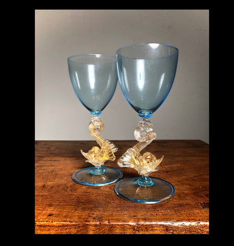 A beautiful pair of blue and gold Venetian Dolphin Goblets.  Handblown Glass. Island of Murano. Salviati Studio. Circa 1960.  Aquamarine Glass with 24 Karat Gold Dolphins.  6.5” tall x 3" diameter  excellent condition   