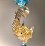 Strange Imports - Aquamarine and gold Venetian Dolphin Candlestick.   Handblown Glass. Island of Murano. Salviati Studio. Circa 1960.  Aquamarine Glass with 24 Karat Gold Dolphins.  11” tall x 5.5" diameter  excellent condition