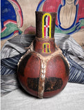 Strange Imports African Art Leather banded water Gourd  Maasai culture  Kenya Circa 1980’s  Vintage water gourd bottle with beautiful beadwork and leather fittings.