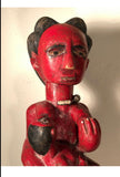 Vintage Puni mother figure from Gabon , circa 1980s-1970s. Custom steel stand elevates this brilliant figure. Carved from a single block of wood. Adorned with beaded necklace and anklet. Mother figure nursing her infant.  